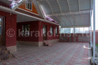 "Каным" - гостевые коттеджи шале с камином: Большая крытая стоянка около главного корпуса администрации